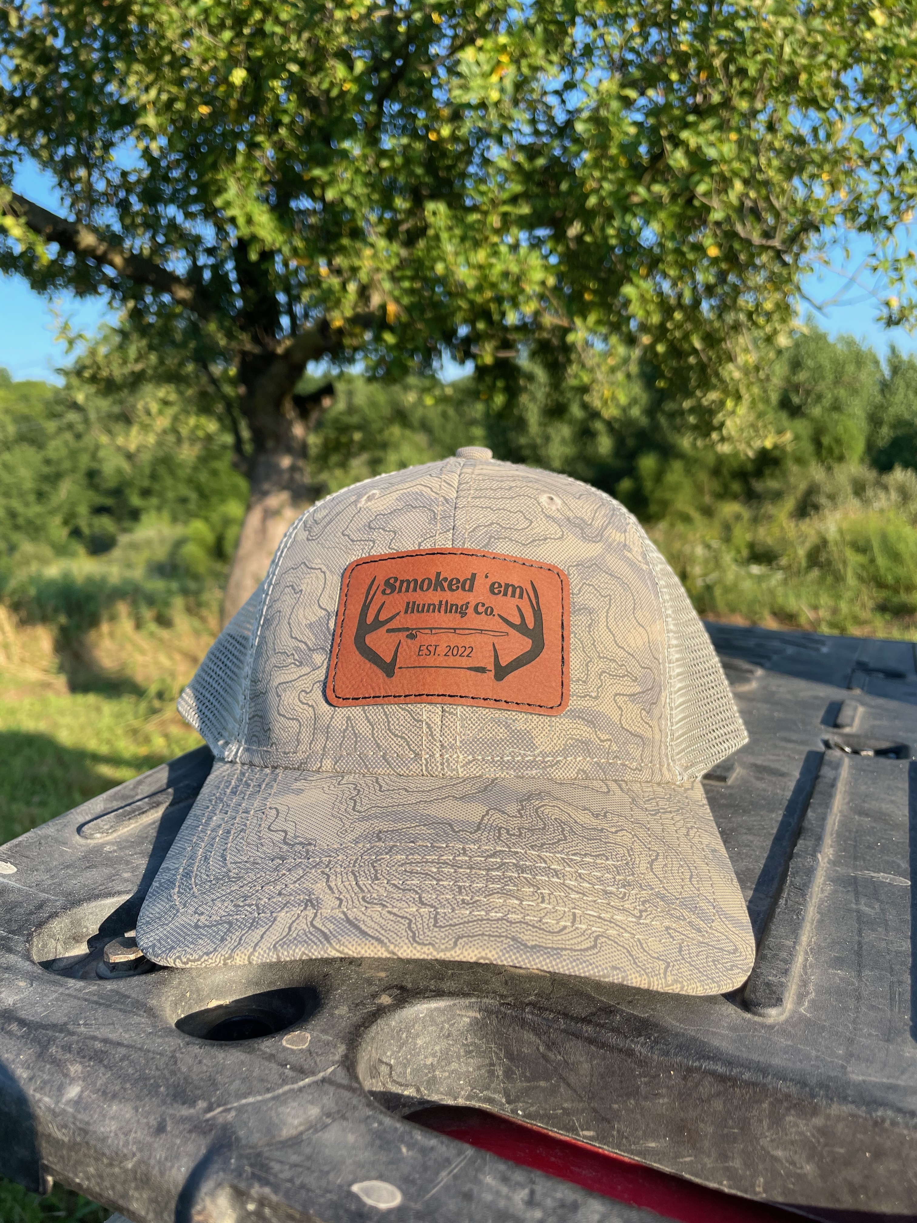 Person wearing gray hat with brown leather patch.